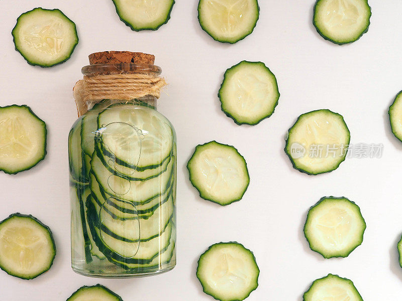 Сucumber slices in a bottle filled with water, cucumber water or skin tonic